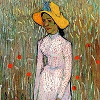 Young Girl Standing Against a Background of Wheat